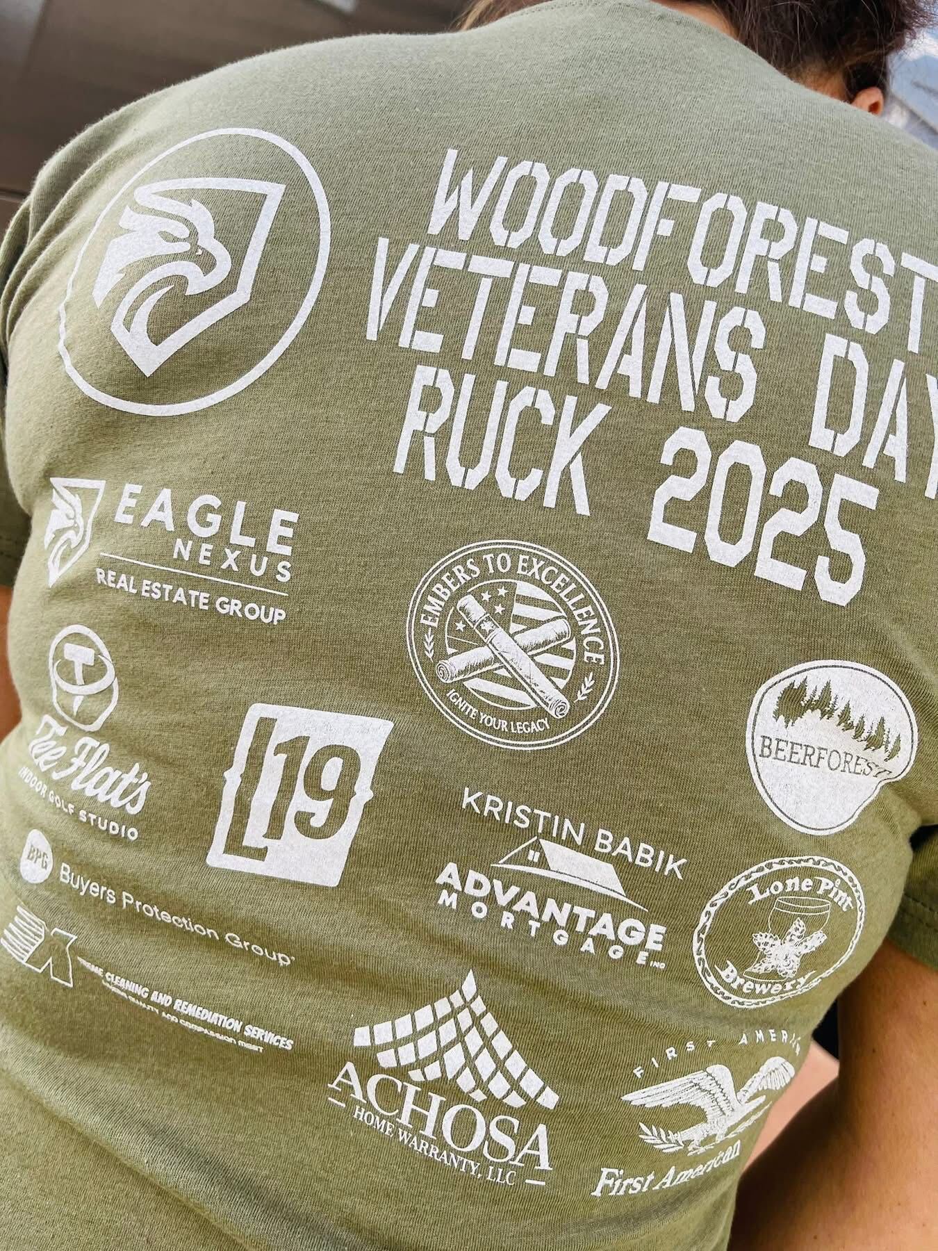 Back of the 2025 Woodforest Veterans Day Ruck shirt showing sponsor logos