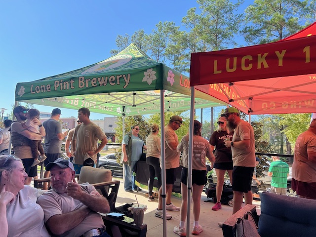 Lone Pint Brewery and Lucky 19 sponsor tents at the post-ruck gathering