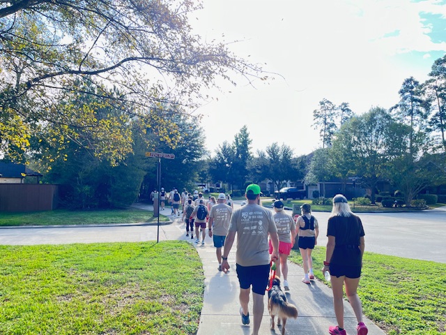 Ruckers walking a neighborhood sidewalk on the Woodforest course